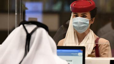 A stewardess of an Emirates Airlines flight from London arrives at Dubai International Airport on May 8, 2020 amid the coronavirus Covid-19 pandemic. (AFP)