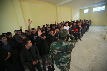 Azerbaijani men gather in a military commissariat to join the army in Tartar region, Azerbaijan on Sept. 30, 2020.  (AP)