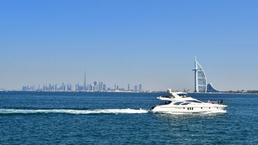 This picture taken on February 8, 2019, shows a yacht with the Burj al-Arab (R) in the foreground and Burj Khalifa (L) in the background. (Giuseppe Cacace/AFP)