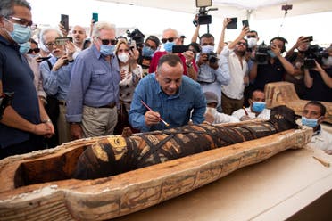 Mostafa Waziri, the secretary-general of the Supreme Council of Antiquities, center, reacts after opening the sarcophagus that is around 2500 years old at the Saqqara archaeological site, 30 kilometers (19 miles) south of Cairo, Egypt, Saturday, Oct. 3, 2020. (AP)
