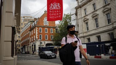 A pedestrian passes the Royal Opera House, which remains closed due to restrictions to slow the spread of the novel coronavirus, in London's West End on July 6, 2020. (AFP)