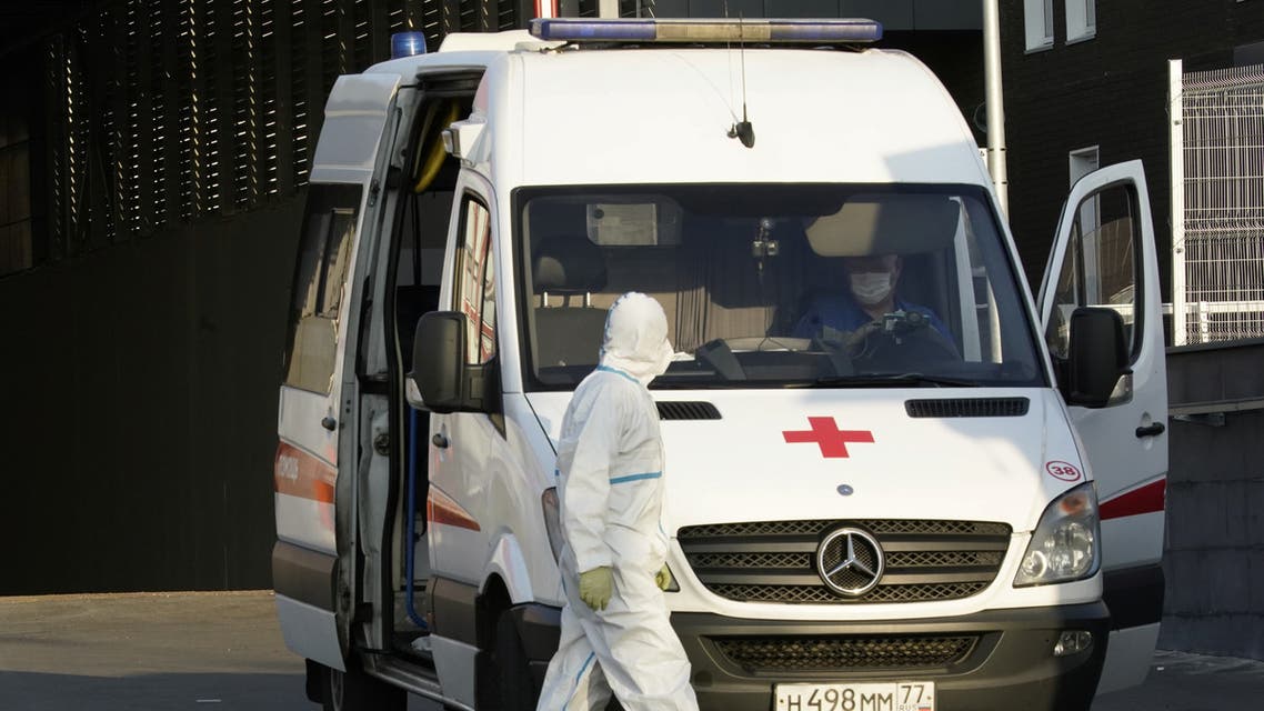 A medical specialist walks next to an ambulance outside a hospital for patients infected with coronavirus disease in Moscow. (Reuters)