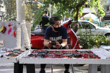 A street vendor wearing a protective face mask to help prevent the spread of the coronavirus in downtown Tehran on Sept. 20, 2020. (AP)