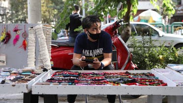A street vendor wearing a protective face mask to help prevent the spread of the coronavirus in downtown Tehran on Sept. 20, 2020. (AP)