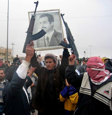 Several hundred armed demonstrators and local residents take to the streets of the town of Fallujah, 50 kms west of Baghdad, 16 December, 2003, chanting pro-Saddam slogans and letting off celebratory gunfire into the air, pledging their allegiance to their deposed leader, and chanting, “We will sacrifice ourselves to you Saddam, with our blood, with our soul.” (AFP)