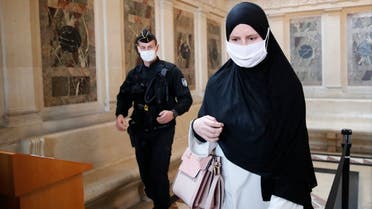 A police officer watches a woman being checked during the trial of a 29-year-old Algerian man accused of killing a woman and trying to blow up a church near Paris, a failed 2015 attack that investigators say was orchestrated by Islamic State extremists in Syria, on October 5, 2020, in Paris. (AP)