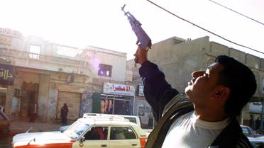 An Iraqi shoots celebratory gunfire in the southern city of Nasiriyah after the capture of ousted Iraqi leader Saddam Hussein in his hometown of Tikrit 14 December 2003. (AFP)