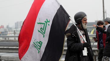 An Iraqi demonstrator holds an Iraqi flag during ongoing anti-government protests in Baghdad, Iraq January 23, 2020. (Reuters)