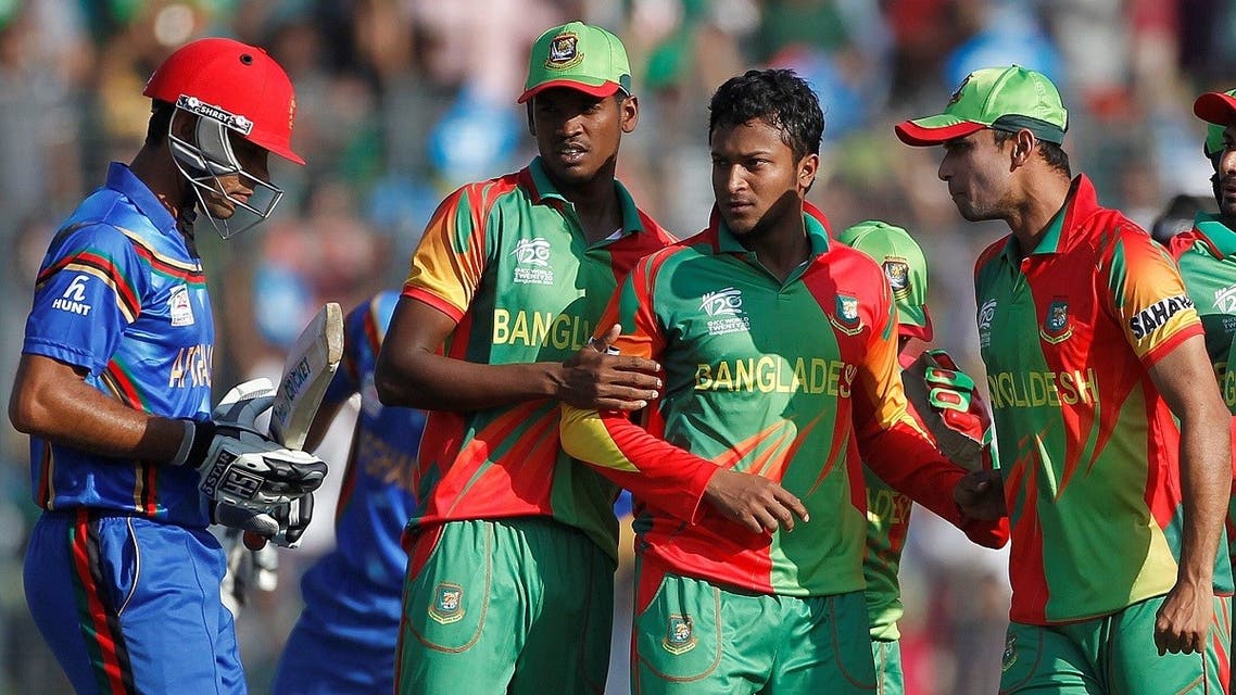 Afghanistan’s Najeeb Tarakai (L) leaves the field as Bangladesh’s Shakib Al Hasan (C) and his teammates celebrate his dismissal during their ICC Twenty20 World Cup match in Dhaka. (File photo: Reuters)