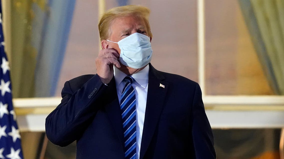President Donald Trump removes his mask as he stands on the balcony outside of the Blue Room as returns to the White House Monday, Oct. 5, 2020, in Washington, after leaving Walter Reed National Military Medical Center, in Bethesda, Md. (AP)