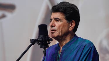 Iran's legendary singer, instrumentalist, and composer Mohammad-Reza Shajarian singing before a microphone in the capital Tehran. (AFP)