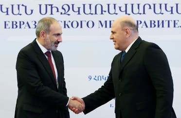 Armenian Prime Minister Nikol Pashinyan (L) shakes hands with Russian Prime Minister Mikhail Mishustin during a meeting of the Eurasian Economic Union's (EAEU) intergovernmental council in Yerevan, on October 9, 2020. (AFP)