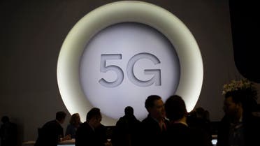 People stand next to a 5G logo during the Mobile World Congress wireless show, in Barcelona, Spain. (AP)