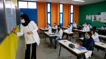 The teacher wears a face mask at Mansour Eddahbi College in the Derb El Kabir district of the AL Fida prefecture in Casablanca, Morocco. (AP)