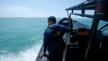 A Malaysia Maritime officer looks out into the sea during a search and rescue in Kuala Langat outside Kuala Lumpur, off Malaysia's western coast, June 18, 2014. (Reuters)