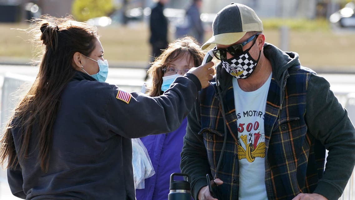 A fan's temperature is taken as he arrives to watch a practice session for the IndyCar auto race at Indianapolis Motor Speedway, Thursday, Oct. 1, 2020, in Indianapolis. (AP)