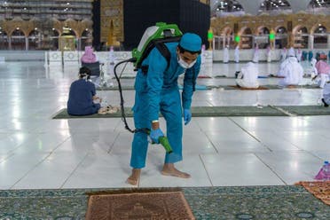 A worker sterilizes the grounds around the holy Kaaba. (Supplied)
