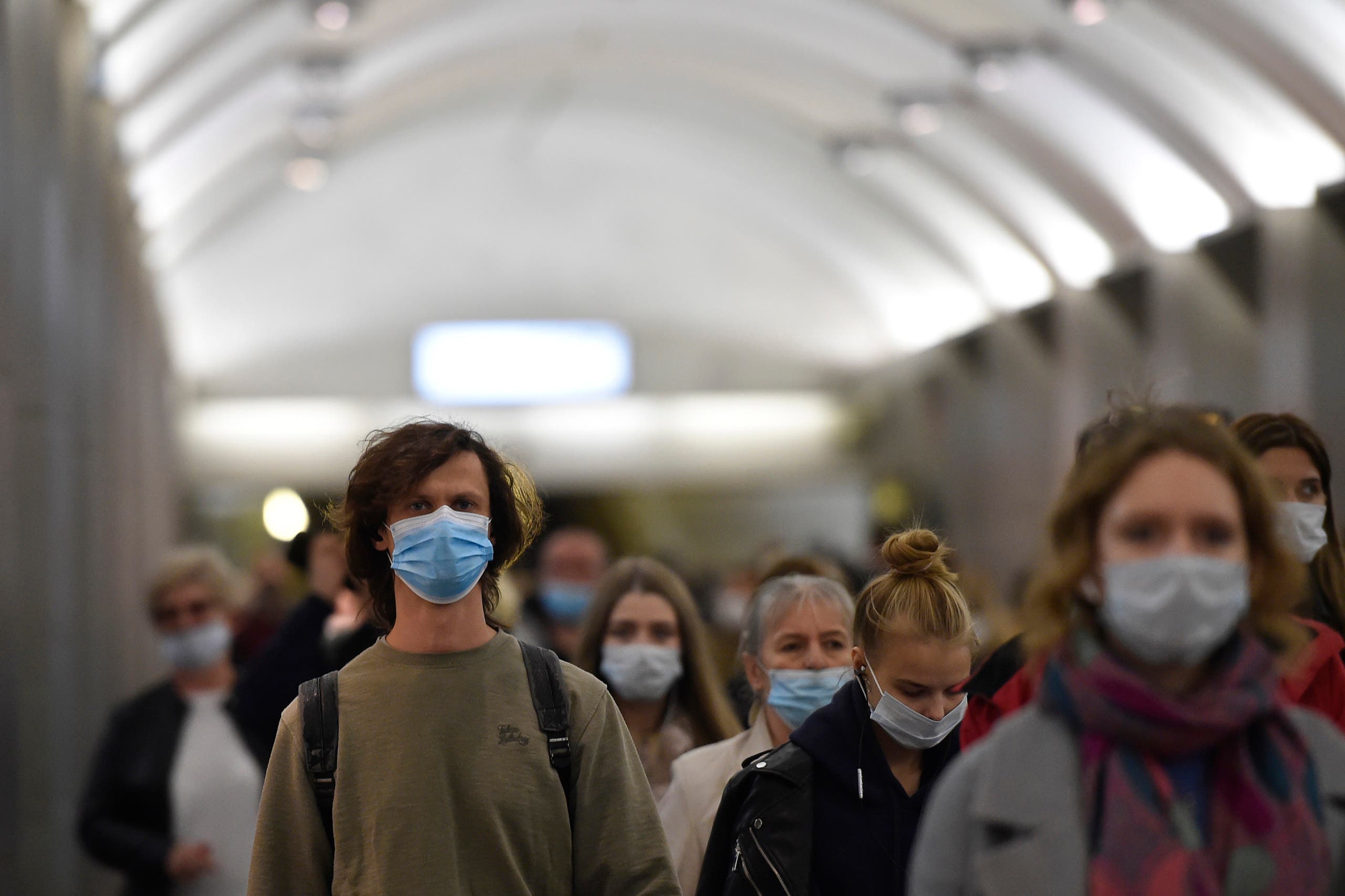 Commuters wearing face masks walk at Sretensky Bulvar metro station in Moscow on October 7, 2020, amid the ongoing coronavirus disease pandemic. (AFP)