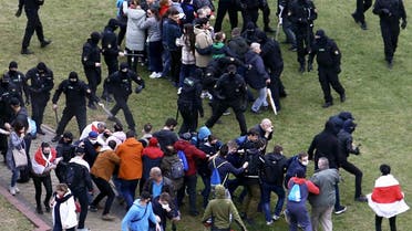 Law enforcement officers scuffle with demonstrators during a rally to protest against the Belarus presidential election results in Minsk on October 11, 2020. (AFP)