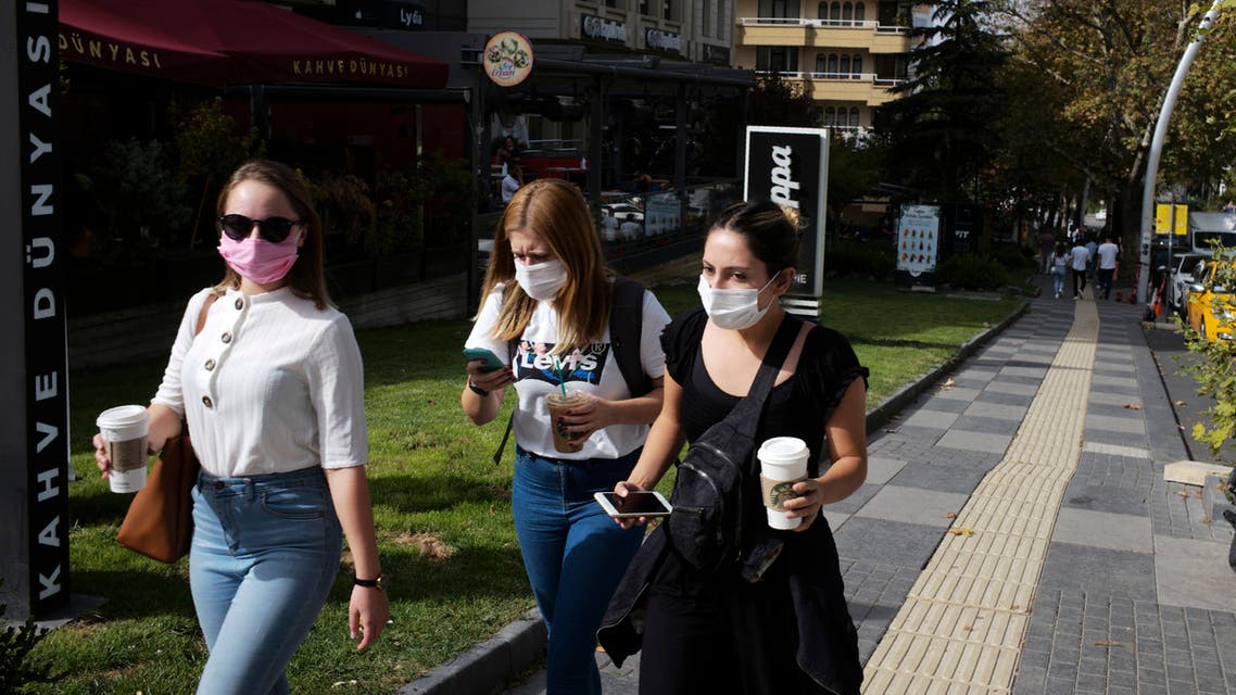 People wearing masks to help protect against the spread of coronavirus, walk in Ankara, Turkey, Thursday, Oct. 8, 2020. (AP)