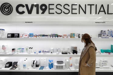 A person looks at the shop window at CV19ESSENTIAL in New York City, September 21, 2020. (Reuters)
