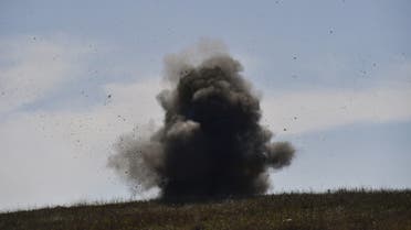 A controlled explosion of collected unexploded cluster bombs by members of a sapper group of the Karabakh Ministry of Emergency Situations on the outskirts of Stepanakert on October 12, 2020, during the ongoing military conflict between Armenia and Azerbaijan over the breakaway region of Nagorno-Karabakh. (AFP)