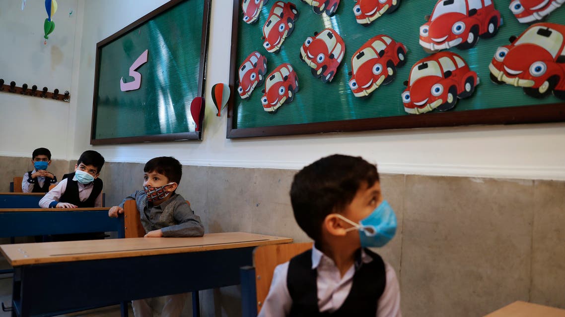 Students wearing protective face masks to help prevent spread of the coronavirus sit at their classroom after the opening ceremony of the Hashtroudi school in Tehran, Iran on Sept. 5, 2020. (File photo: AP)