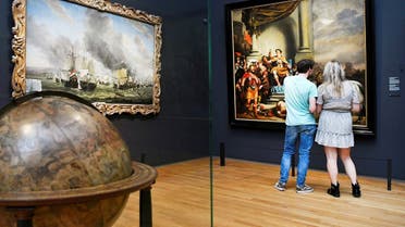 People look at a painting at the Rijksmuseum that reopened as Netherlands eases some of the lockdown measures put in place during the coronavirus outbreak, in Amsterdam, Netherlands. (Reuters)