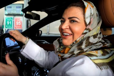 Samira al-Ghamdi, a practicing psychologist, smiles while making a stop to refuel her car as she drives to work in Jeddah, Saudi Arabia June 24, 2018. (Reuters)