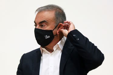 Carlos Ghosn, the former Nissan and Renault chief executive, adjusts his protective face mask during a news conference at the Holy Spirit University of Kaslik, in Jounieh, Lebanon September 29, 2020. (Reuters)