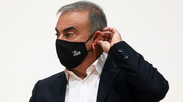 Carlos Ghosn, the former Nissan and Renault chief executive, adjusts his protective face mask during a news conference at the Holy Spirit University of Kaslik, in Jounieh, Lebanon September 29, 2020. REUTERS/Mohamed Azakir