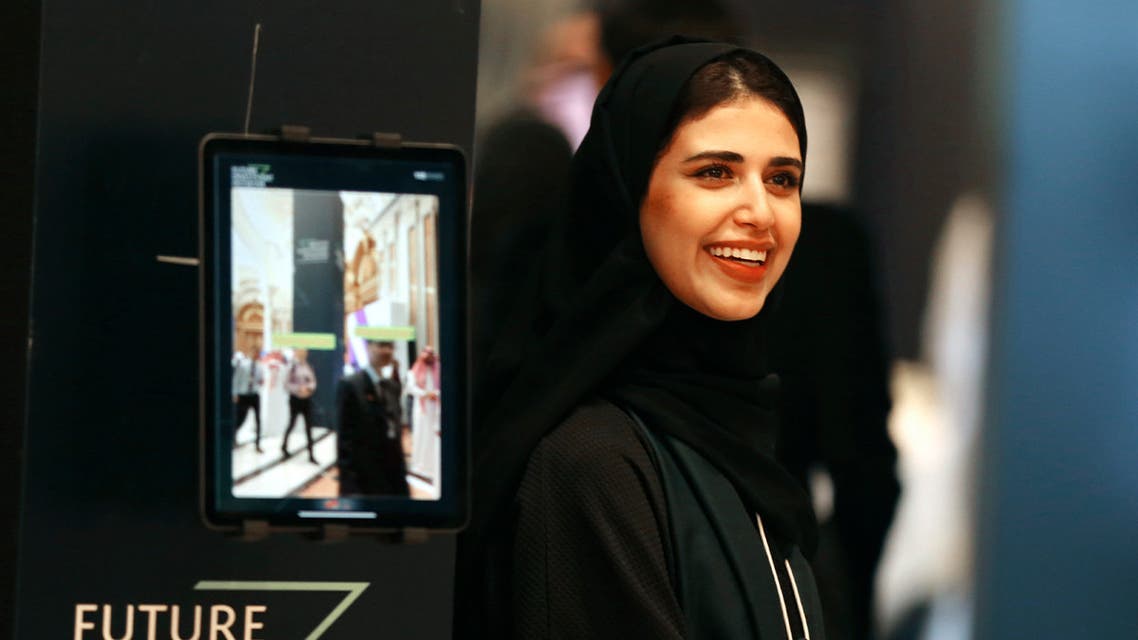 A Saudi organizer at the Future Investment Initiative conference, FII, smiles as she welcomes participants, in Riyadh, Saudi Arabia on Oct. 29, 2019. (AP)