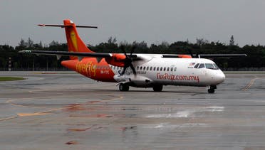 FireFly airline ATR 72-500 aircraft taxis to the airport terminal at Changi airport on a rainy day in Singapore. (Reuters)