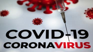 This photograph taken on Oct. 7, 2020 shows a syringe on an illustration representing Covid-19 in Toulouse, southwestern France. (AFP)