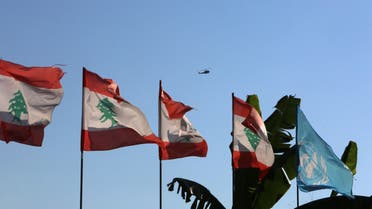 Lebanese and UN flags flutter as an aircraft flies in Naqoura ahead of talks between Israel and Lebanon on disputed waters, near the Lebanese-Israeli border. (Reuters)