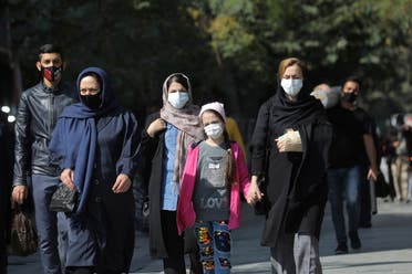 Iranians wearing face masks walk on a street after Iranian authorities made it mandatory for all to wear face masks in public following the outbreak of the coronavirus disease (COVID19), in Tehran Iran October 10, 2020. (Reuters)