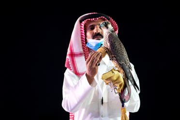 A Saudi man displays the falcon during the auction in King Abdulaziz Festival in Mulham, north of Riyadh, Saudi Arabia, October 13, 2020. (Media Center Saudi Falcons Club Auction via Reuters)