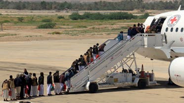 Houthi prisoners board a plane before heading to Sanaa airport after being released by the Saudi-led coalition in a prisoner swap, at Sayoun airport. (Reuters)