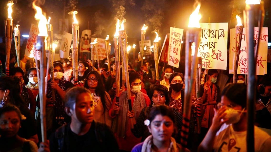 Female activists and students take part in a torch procession demanding women's safety and justice for rape victims in Dhaka, Bangladesh, on October 14, 2020. (Reuters)
