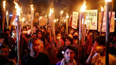 Female activists and students take part in a torch procession demanding women's safety and justice for rape victims in Dhaka, Bangladesh, on October 14, 2020. (Reuters)