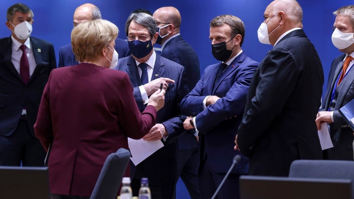 German Chancellor Angela Merkel, center left, speaks with French President Emmanuel Macron, center right, and Cypriot President Nicos Anastasiades, center, during a round table meeting at an EU summit in Brussels, on October 16, 2020.  (AP)