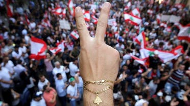 A demonstrator flashes a V sign during an anti-government protest in Downtown Beirut, Oct. 21, 2019. (Reuters)