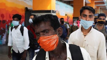 Passengers wearing face masks stand in line to get tested for coronavirus, at a railway station, in New Delhi, India, Oct. 5, 2020. (Reuters)