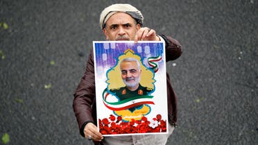 A Yemeni supporter of the Huthi movement holds a poster of slain Iranian major general Qassem Soleimani during a demonstration in Sanaa on January 6, 2020 to denounce the US killing of the top Iranian general and Iraqi paramilitary chief Abu Mahdi al-Muhandis. Soleimani and al-Muhandis were killed in a US drone strike near Baghdad's international airport, sparking fury in Iran and Iraq.