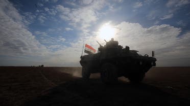 Iraqi forces, supported by members of the Hashed al-Shaabi (Popular Mobilisation units), advance through the Salaheddin province in the western desert bordering Syria after leaving the town of Baiji, on November 25, 2017, as they attempt to flush out remaining Islamic State (IS) group fighters in the Al-Jazeera region. 