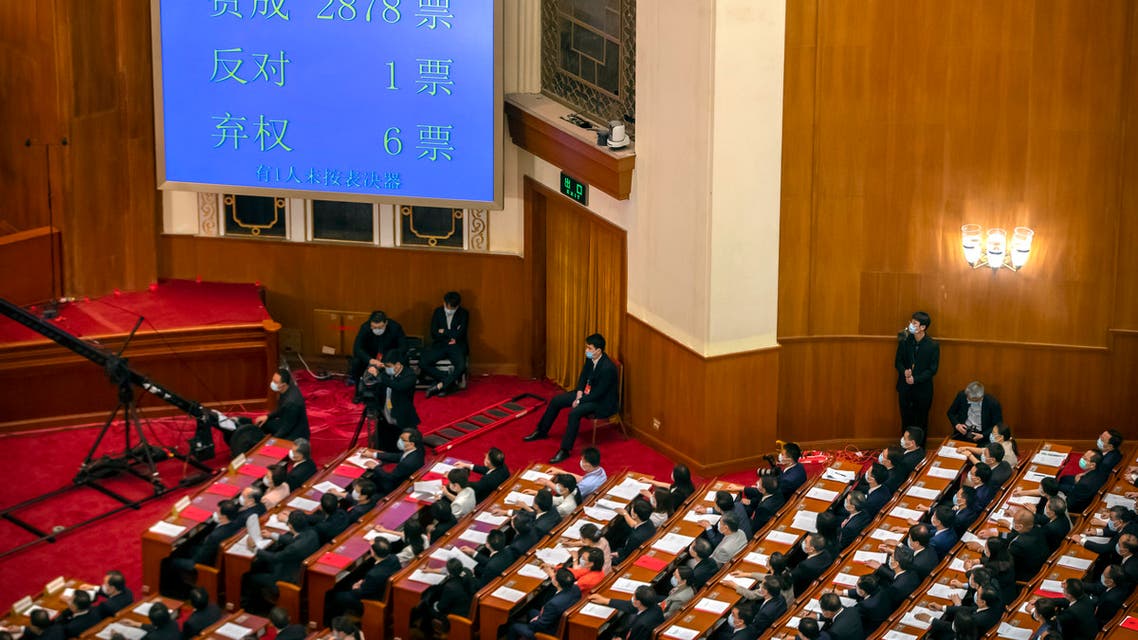 In this May 28, 2020, file photo, delegates applaud as a video screen shows the results of the vote on a piece of national security legislation concerning Hong Kong. (AP)