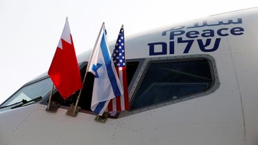 The national flags of Bahrain, Israel and America, are seen attached to the Israeli flag carrier El Al plane that will fly an Israeli delegation, accompanied by U.S. aides, to Bahrain to formalise relations and broaden Gulf cooperation, at Ben Gurion International Airport, in Lod, near Tel Aviv, Israel October 18, 2020. REUTERS/Ronen Zvulun/Pool