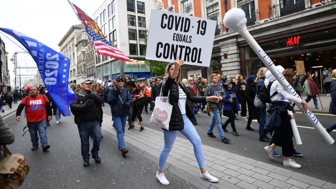 Protesters walk down Oxford Street at a demonstration against vaccinations and government restrictions designed to fight the spread of the coronavirus in London on October 17, 2020. (AFP)