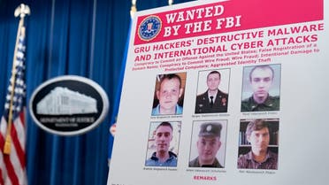 A poster showing six wanted Russian military intelligence officers is displayed before a news conference at the Department of Justice, Oct. 19, 2020, in Washington. (AP)