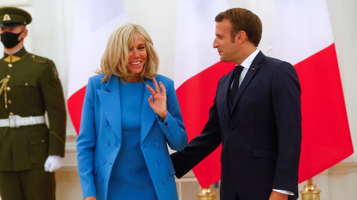 French President Emmanuel Macron and his wife Brigitte react as they pose for a picture, in Vilnius, Lithuania September 28, 2020. REUTERS/Ints Kalnins